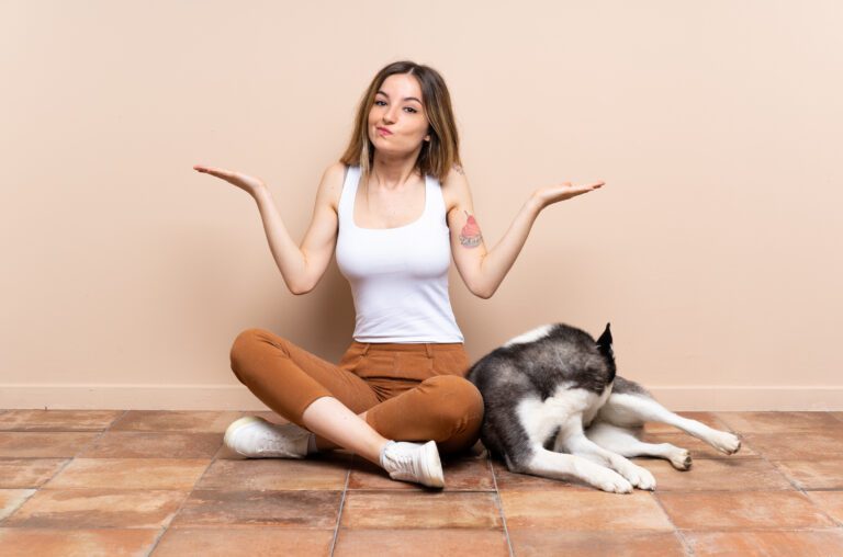 Woman and husky pondering solutions for dog's old joints for safe play