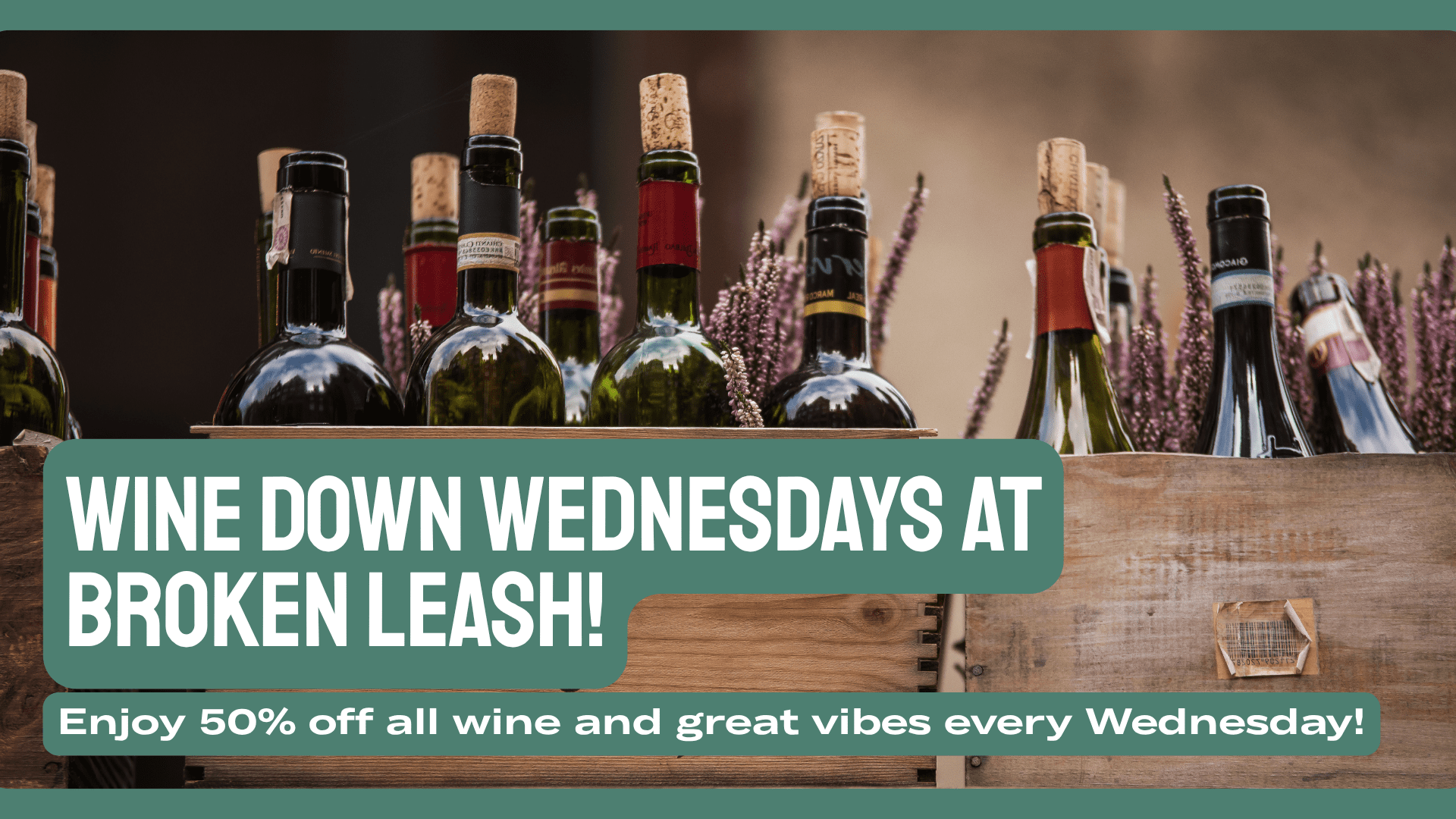 Glass of red wine at a table with a dog nearby at a dog-friendly bar in North Charleston